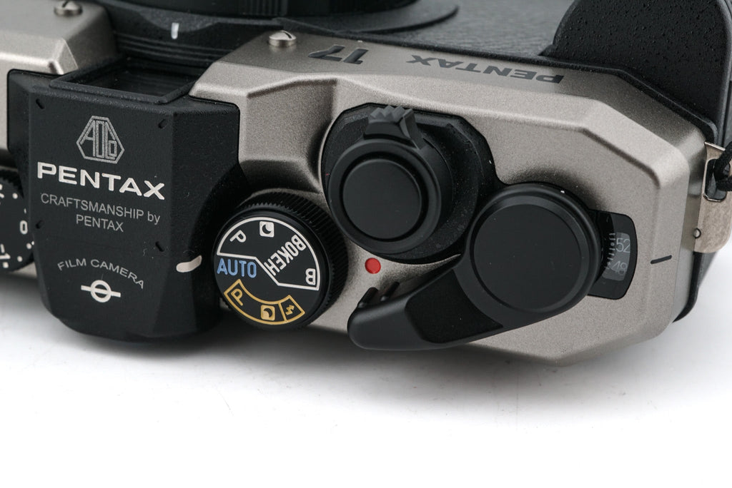 A close-up of Pentax 17 half-frame camera top right side view on a white background.