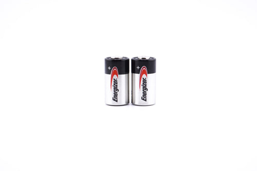 A close-up of Two Energizer 4LR44 / A544 6V batteries with a white background.